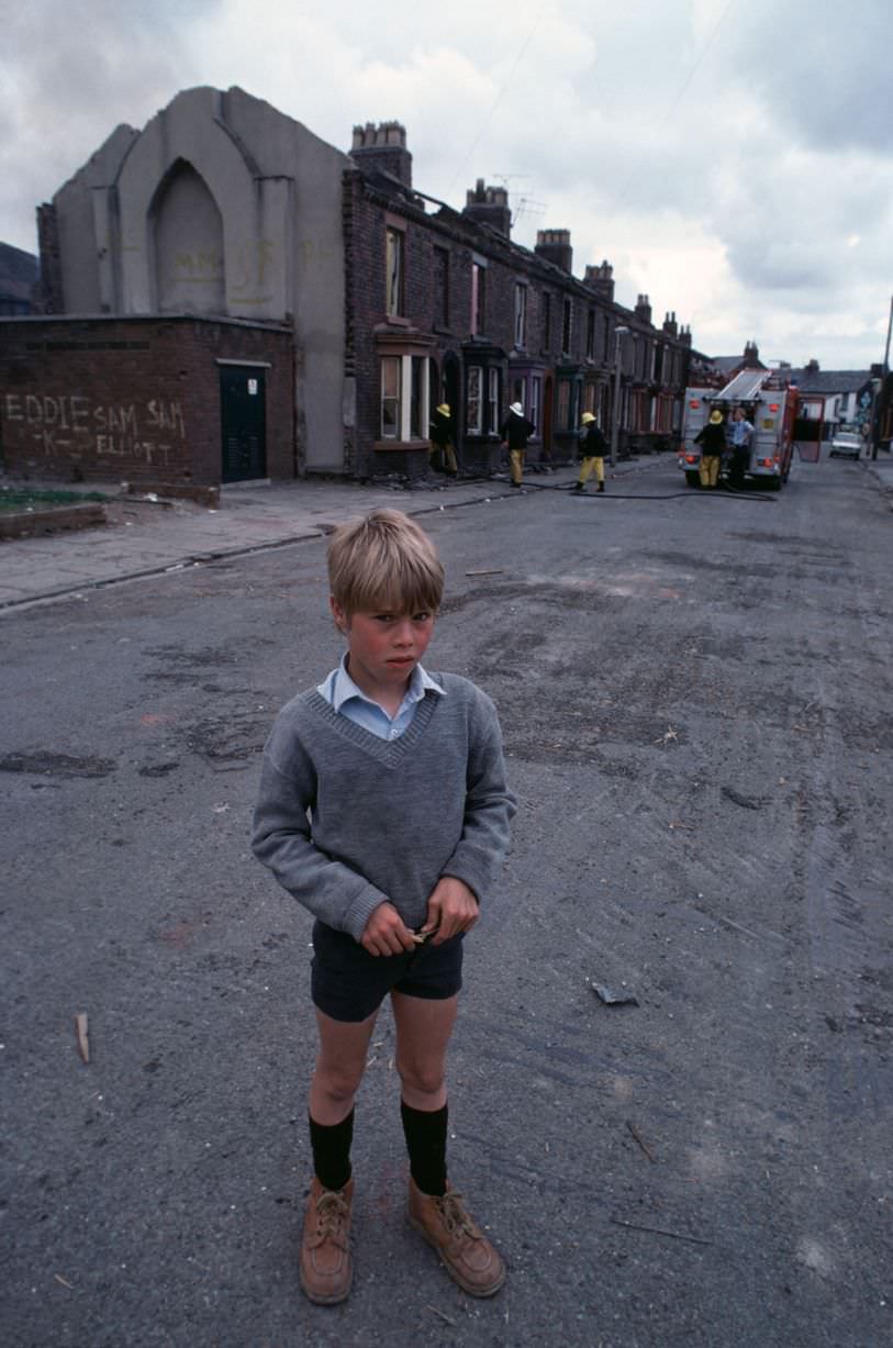 #70 Boy standing in the street in Toxteth in 1981