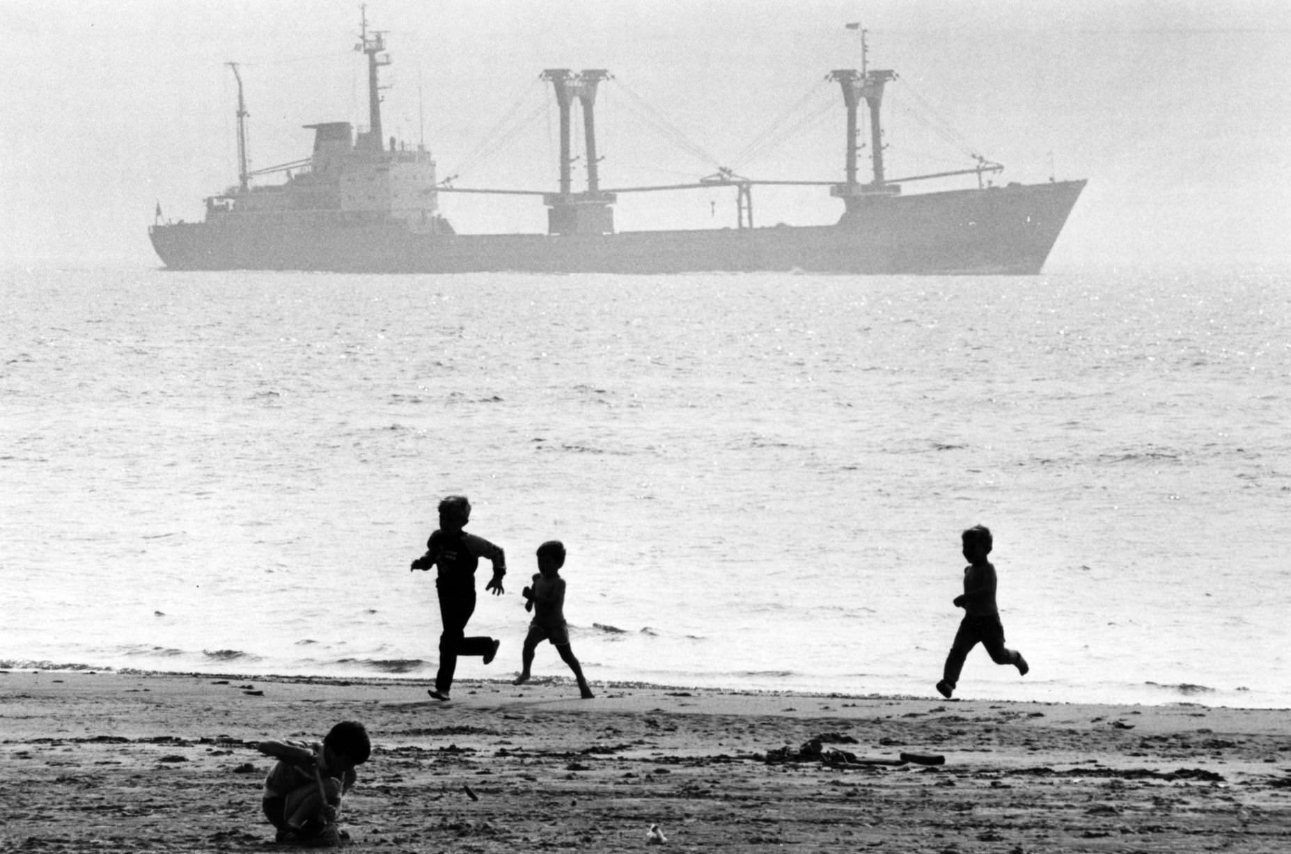 #74 Children enjoying the summer holidays on Crosby beach. Crosby, Sefton, Merseyside. August 1984