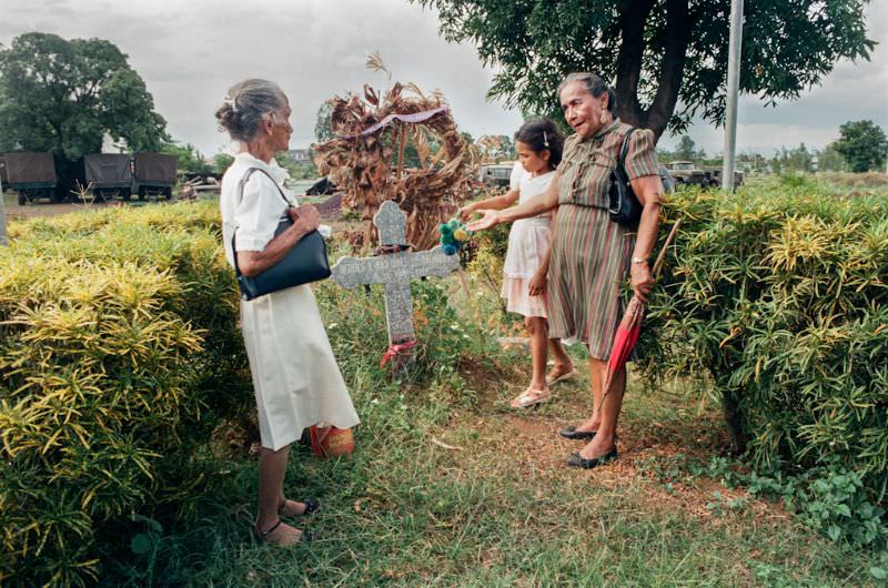 #14 Doña Mercedes with her sister and her granddaughter Anna visit the grave of her son.