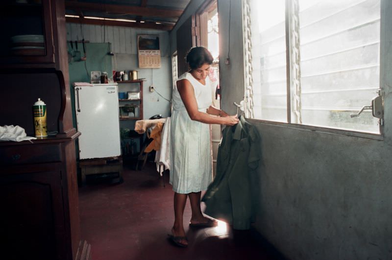 #19 Elba, Julio’s wife, irons his uniforms. They live with their son in the Montano home, Managua, Nicaragua, 1985
