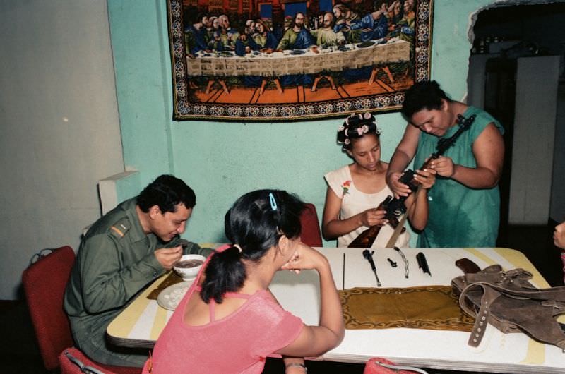 #27 Milena and her cousins clean the gun to prepare for civil defense, Managua, Nicaragua, 1985