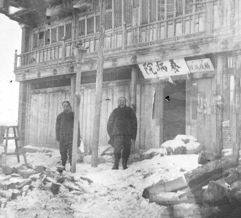 Dr. Ku and assistant in front of ‘old style’ Chinese plague hospital, Fuchiatien