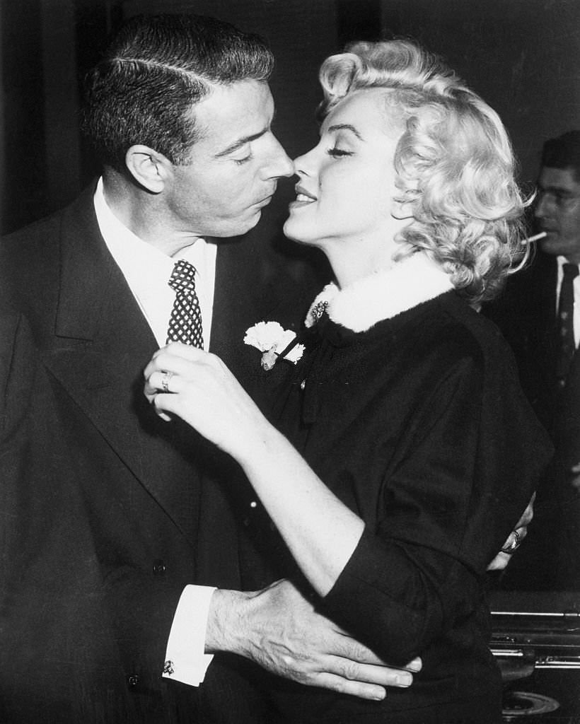 Joe DiMaggio and Marilyn Monroe kiss following their marriage ceremony in a judge’s chambers in San Francisco, California.