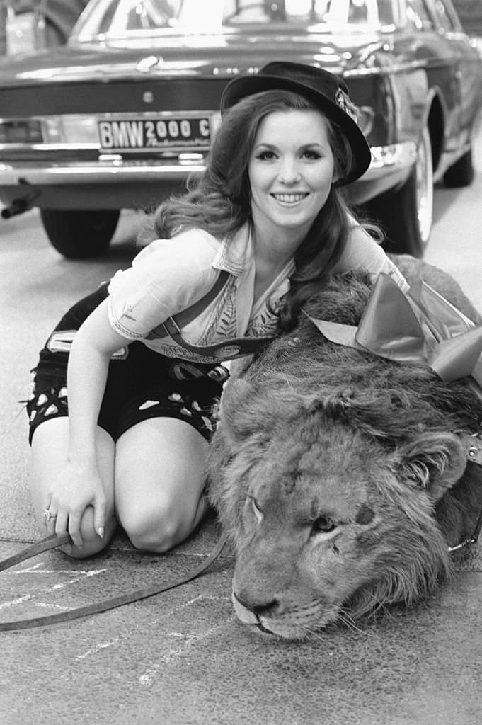 #23 Statuesque model Nell Theobald poses April 8 with Ludwig, a lion, during a promotion session inside the New York Coliseum for an automobile manufacturer.