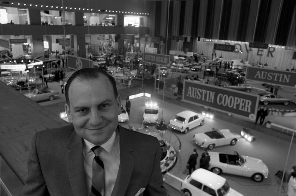 #24 Lee Iacocca automobile executive, displaying a range of Fords at an auto show, New York, US, 1964.