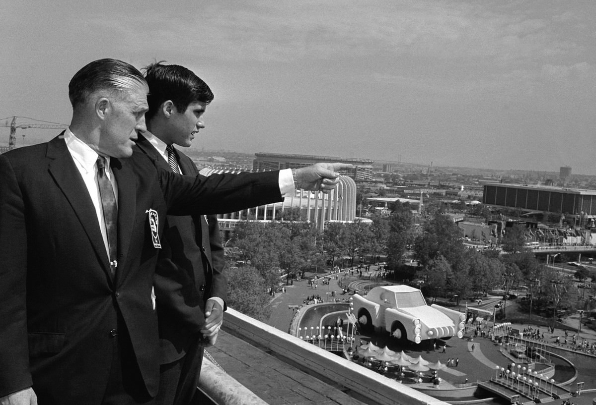 #17 Michigan Governor George Romney and his son, Mitt, look out over the New York World’s Fair grounds.