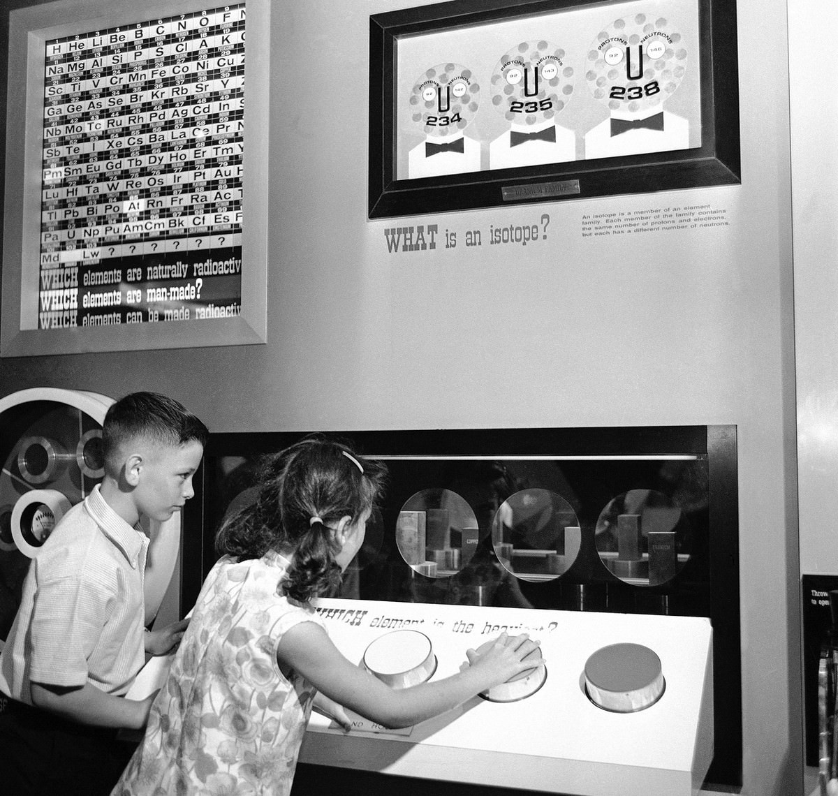 #18 One many displays designed to brief youngsters on the fundamentals of atomic energy at the Atomic Energy Commission’s “Atomsville, U.S.A.”, this one demonstrates relative weight.