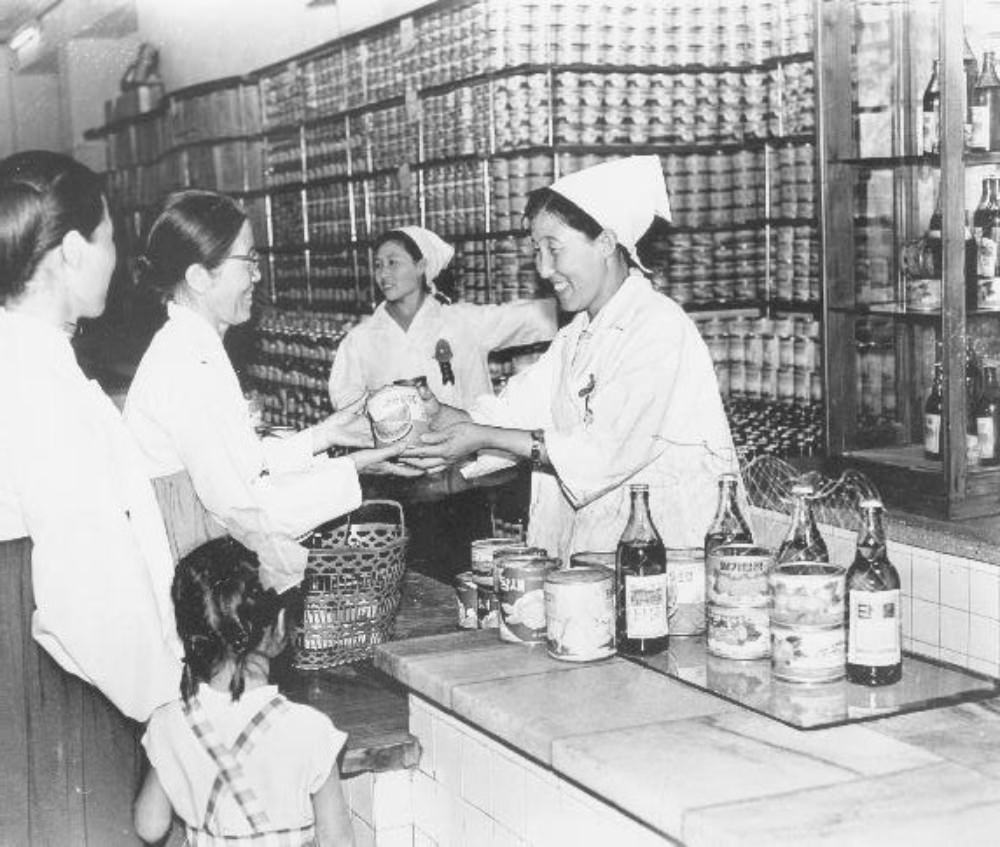 #9 Clerks selling canned strawberry, watermelon, vegetables, bottles of juice, Pyongyang, North Korea, June 1972