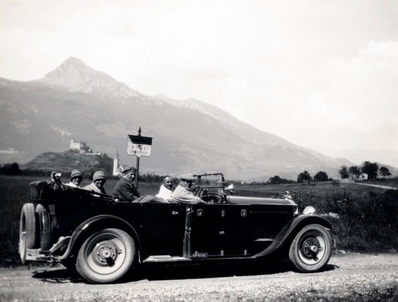 #1 A company of five posing in a 1925 open-top Packard Eight Phaeton on a gravel road in the countryside, 1925