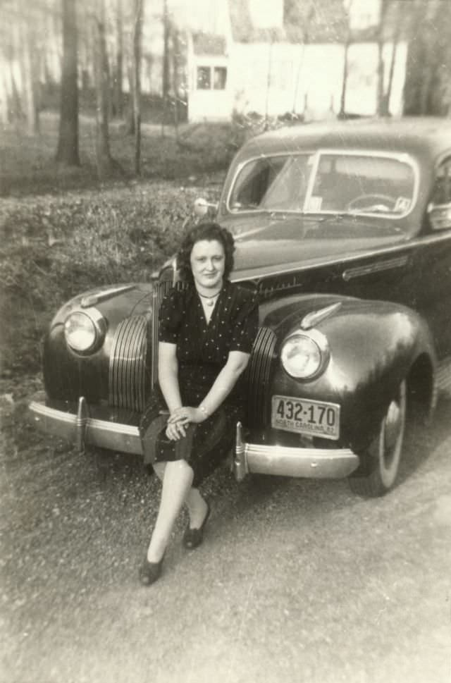 #18 A lady in a polka dot dress posing on the bumper of a 1941 Packard Special.