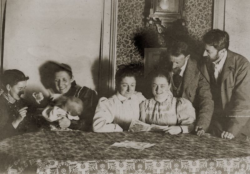 #1 Family reading around the dining room table, circa 1900