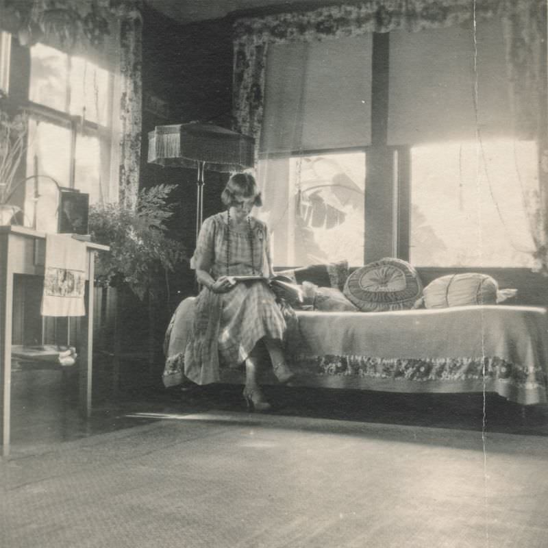 #16 Woman reading in the sitting room, circa 1930s