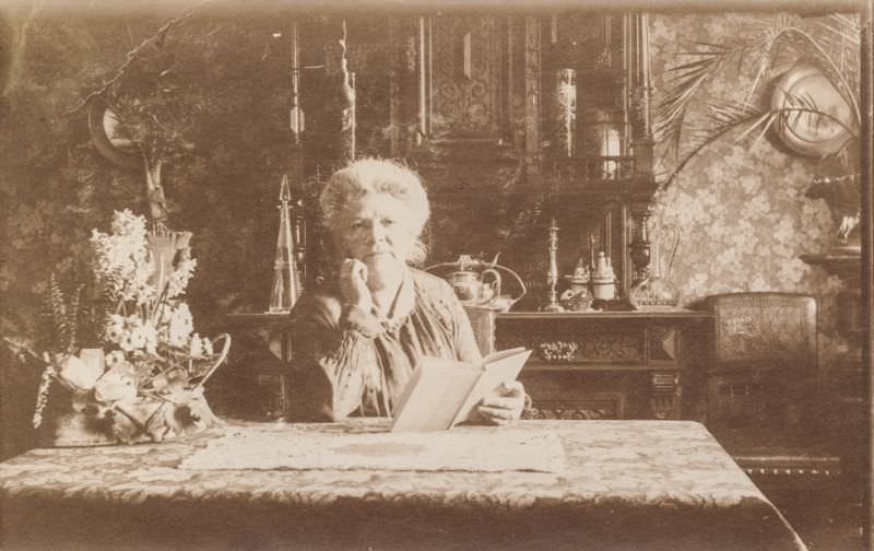 #22 Elderly woman reading a book in her parlor