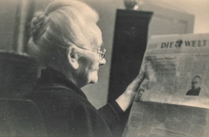 #24 Elderly woman reading a newspaper