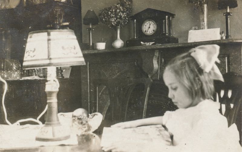 #26 Little girl reading at a table