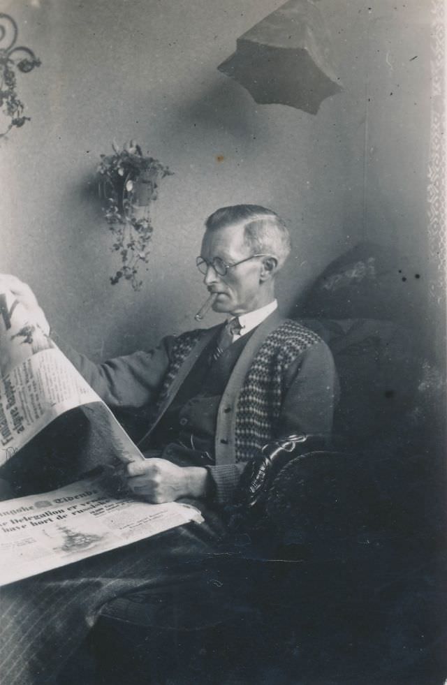 #32 Old Danish man reading the paper and smoking a cigar
