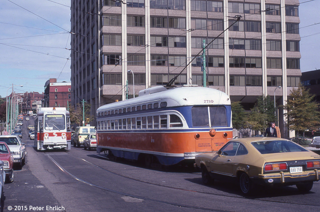 #76 PCC 2710, outbound on Route 10, has just emerged from the subway, and is about to pass Kawasaki 9078, in training service.
