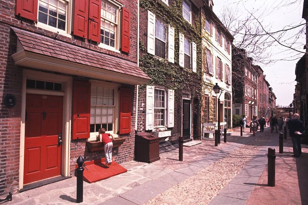 #54 A young boy looks in the window a house (built in 1720) on Elfreth’s Alley in the Old City neighborhood , Philadelphia, 1980.