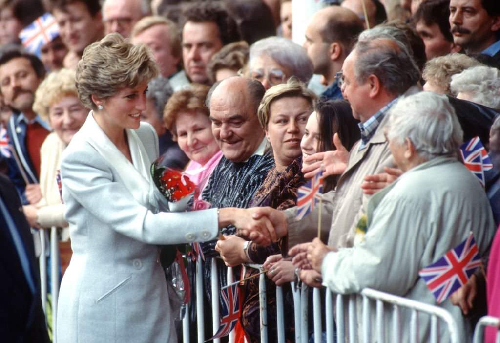 #24 Diana, Princess of Wales, shakes hands with a well-wisher as she visits Wenceslas Square on May 6, 1991 in Prague.