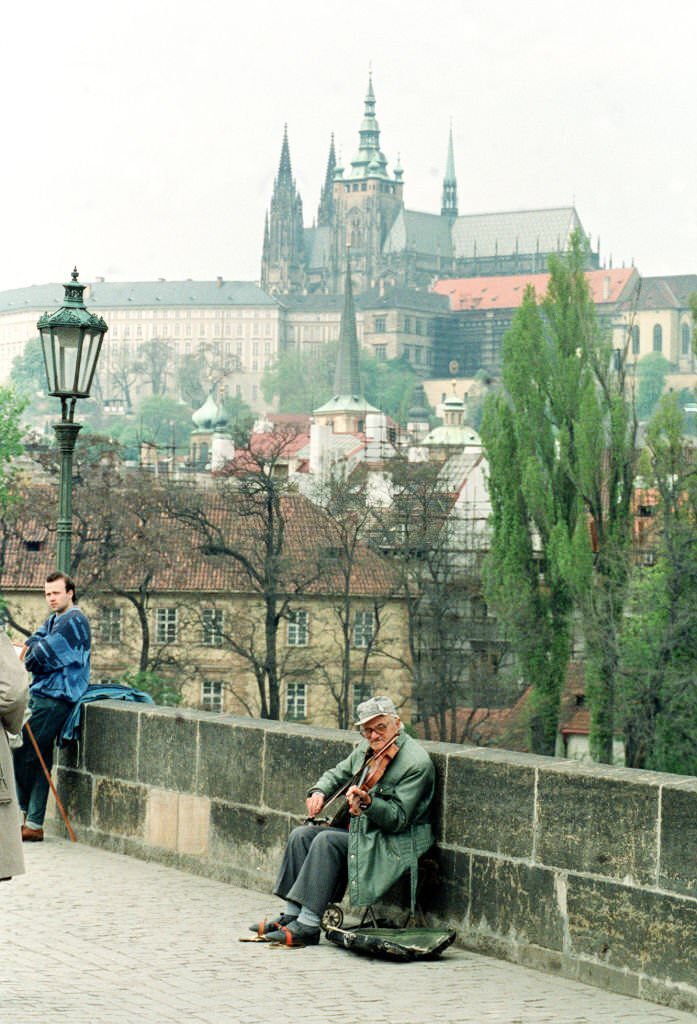 #3 A musician plays on Charles Bridge in Prague in the shadow of the city’s castle and St Vitus Cathedral.