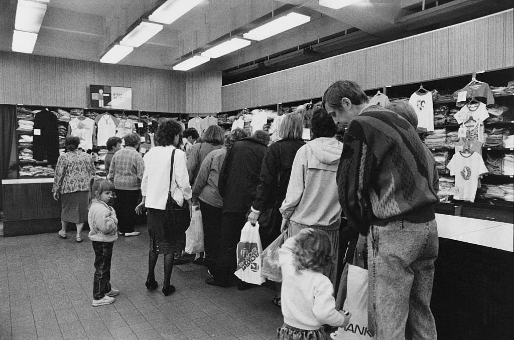 #33 People queuing at a clothing store in Prague, Czechoslovakia, 5th June 1990.