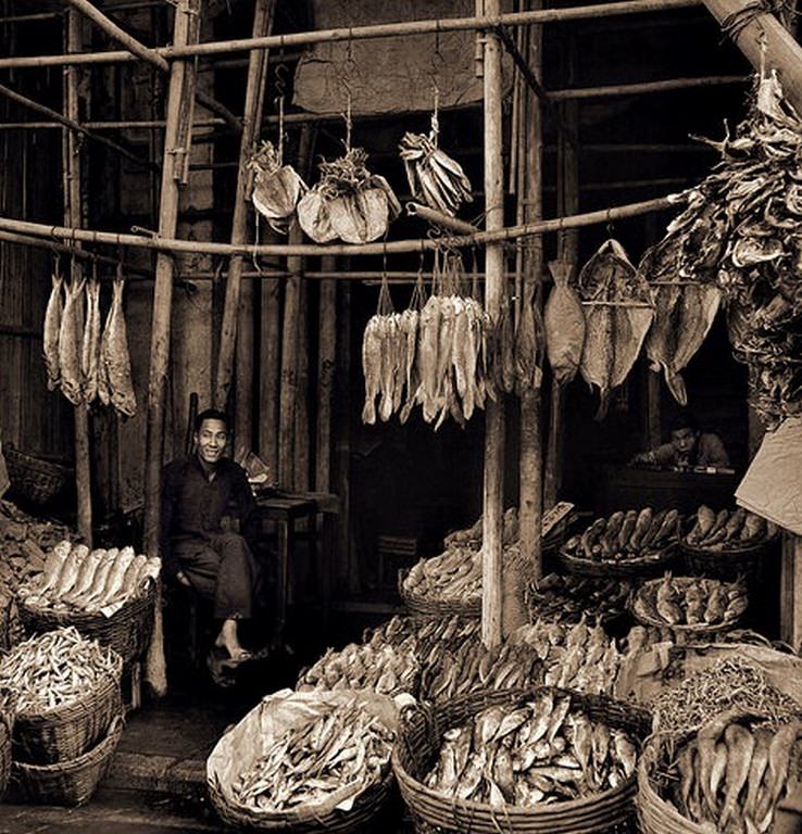 #78 Seated Man Amid Baskets of Fish & Hanging Dried Fish, Eastern Districts, Hong Kong Island, 1946