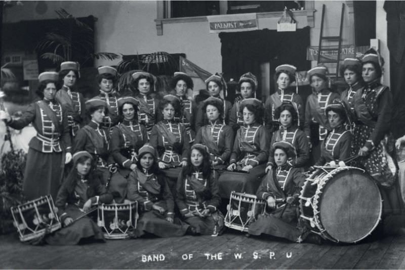 #12 The Drum & Fife Band performing in a procession to promote the Women’s Exhibition, May 1909