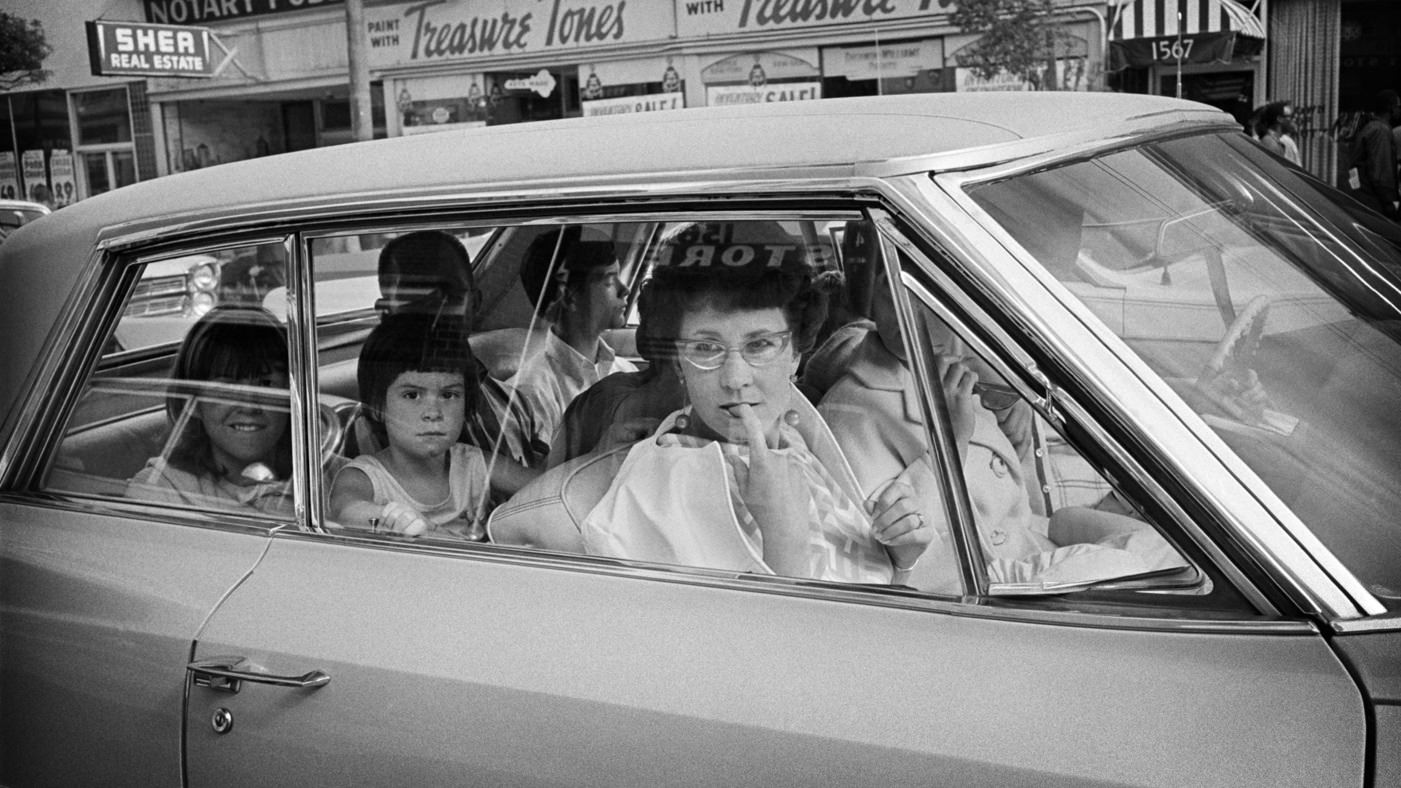 #10 Tourists observe the Haight from their cars in 1967.