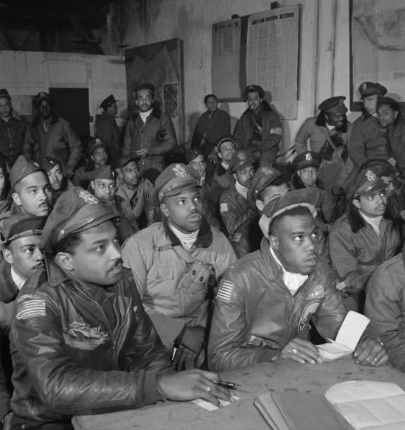 #1 Several Tuskegee airmen attending a briefing in Ramitelli, Italy, March 1945