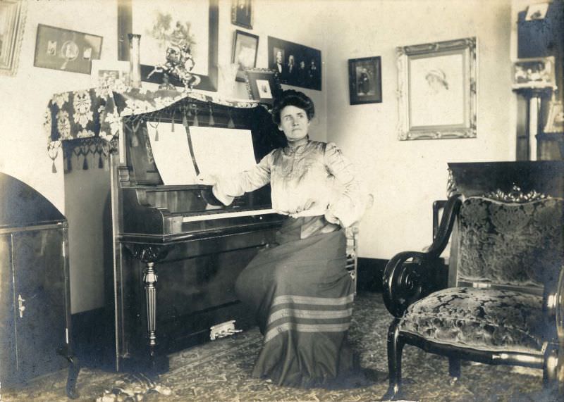 #21 Woman seated at piano in living room