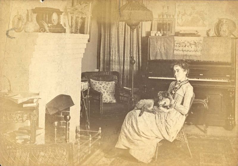 #22 Woman seated by fireplace with dog in lap
