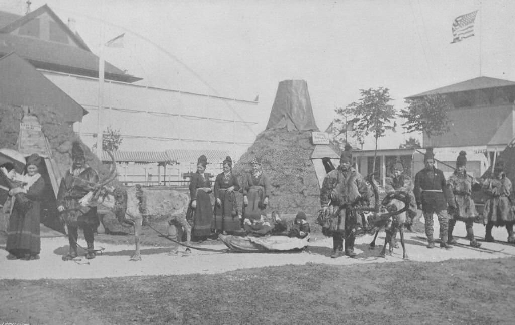 #71 An interior view of the Lapland Village at the Midway Plaisance, showing natives and reindeer during the World’s Columbian Exposition in Chicago, 1893.