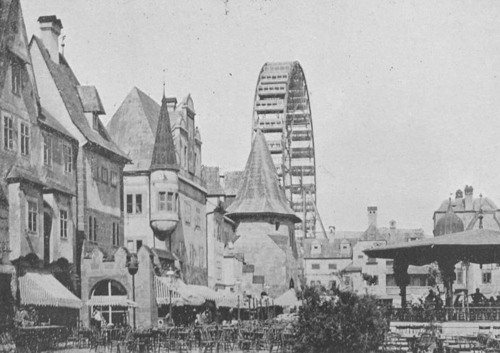 #56 An interior view of the Street of Vienna and Ferris Wheel at the Midway Plaisance during the World’s Columbian Exposition in Chicago, 1893.