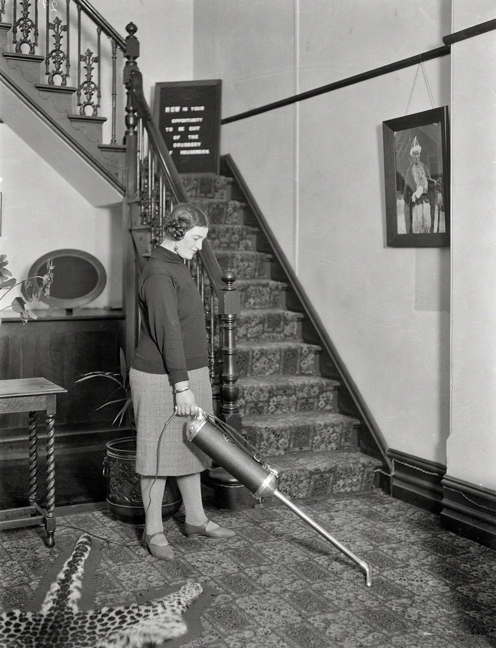 #27 Woman using a vacuum cleaner in a hallway, Wellington, New Zealand
