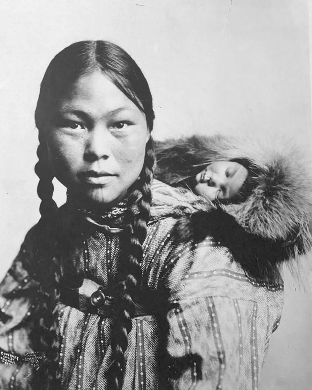 #24 Eskimo mother with child on back.