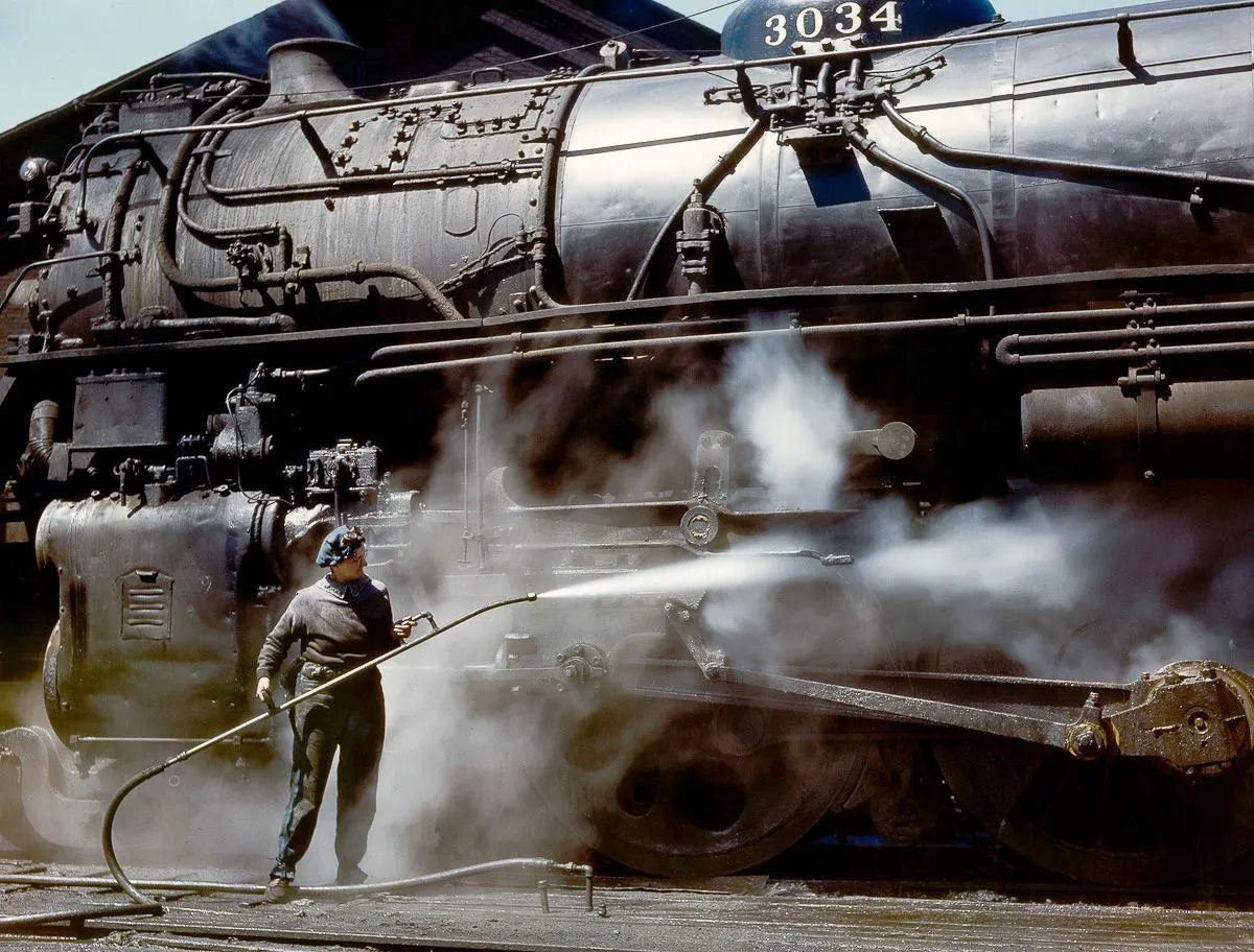 #11 Mrs. Viola Sievers sprays an H-class locomotive with steam.