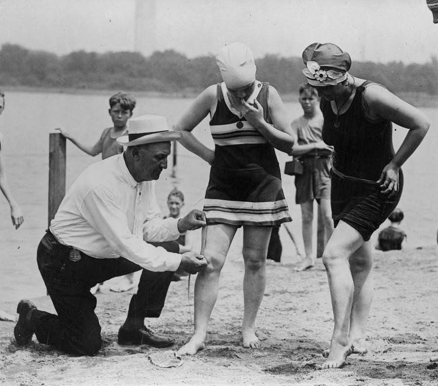 Beach policeman Bill Norton measures the distance between a woman’s knee and the bottom of her swimsuit to be sure that it’s not too large — in keeping with rules of the time — in Washington, D.C., 1922.