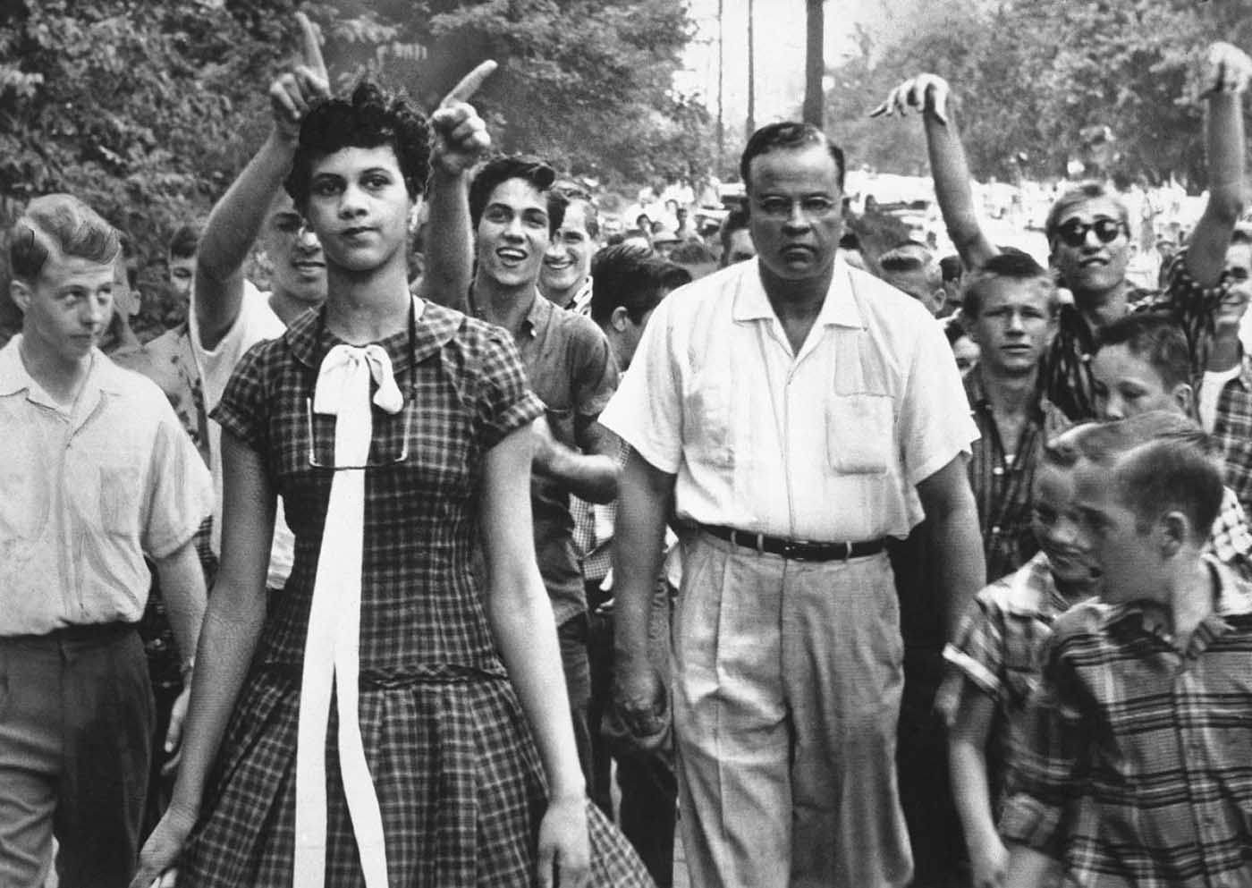 #1 Dorothy Counts, 15, is taunted and harassed by white students as she makes her way from Harding High School in Charlotte, North Carolina.