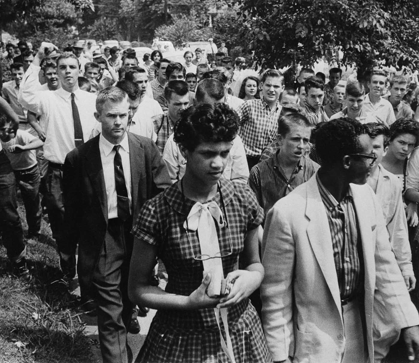 #2 Counts is escorted from school, followed by a crowd of 100 jeering students.