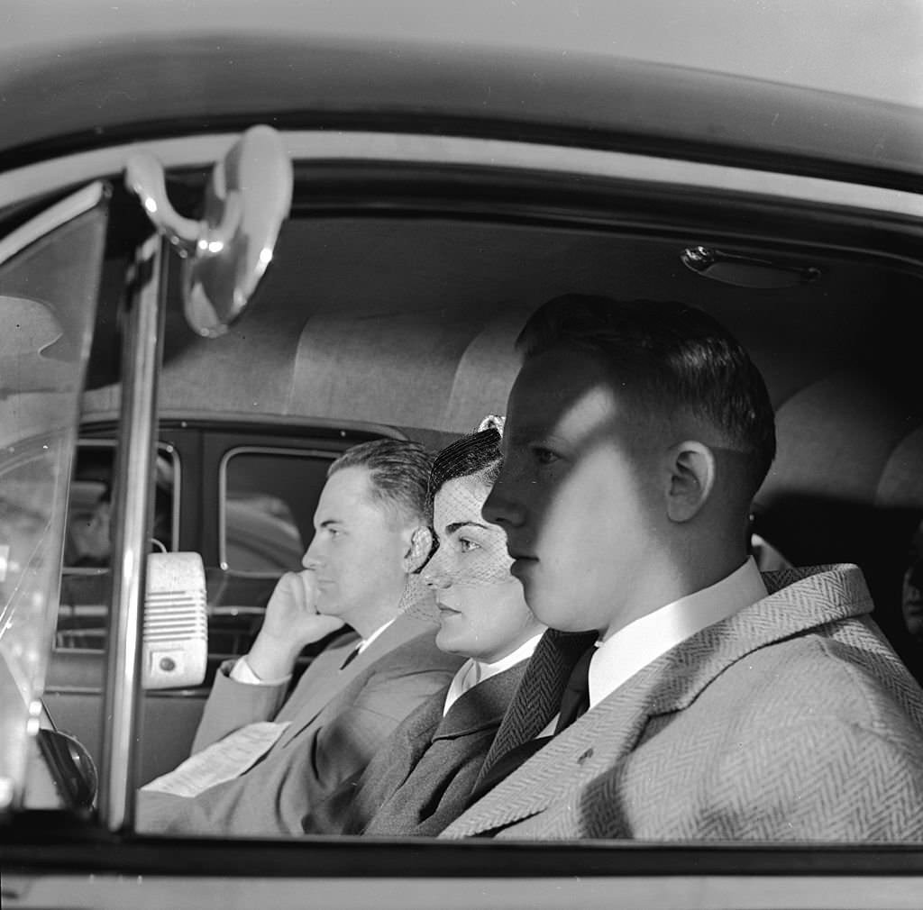 #11 A trio of worshippers sit in their automobile during the Sunday Service at the Drive-In theatre, 1955