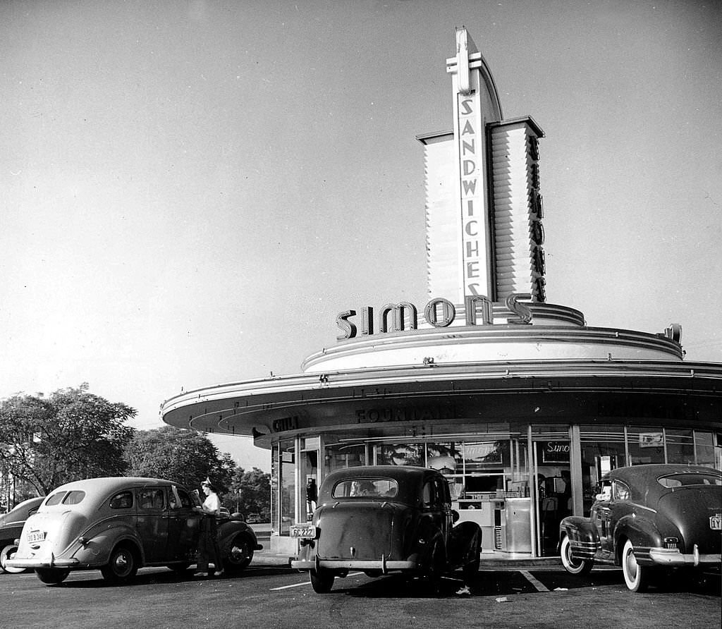 #31 Three cars parked at a Los Angeles drive-in cafe, with a waitress serving at one car