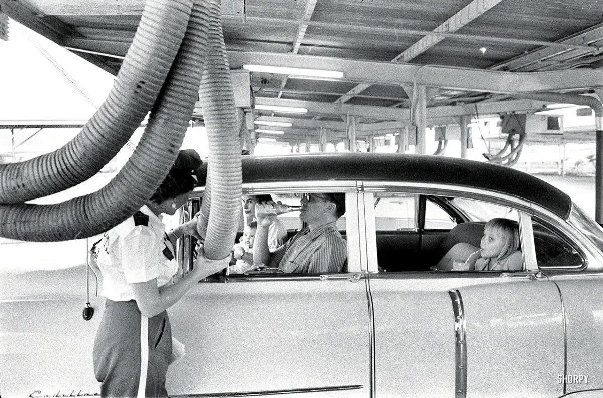 #38 A family at a drive-in restaurant has cool air piped into their car. 1957.