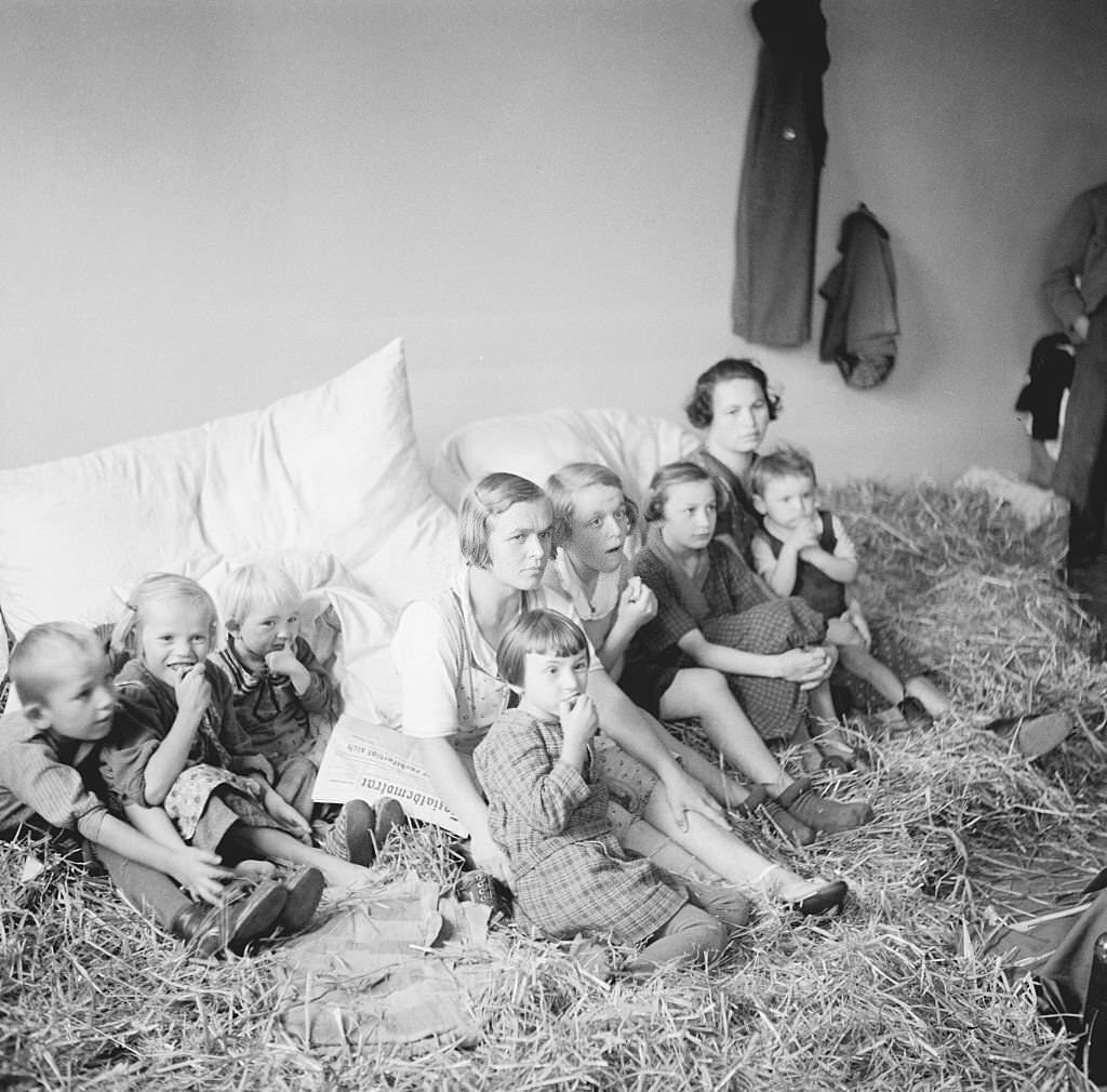 #108 Czech Refugee Children sitting on Straw.