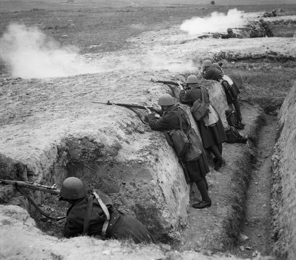 #112 Czechoslovakian troops stand in a trench with rifles, preparing to defend themselves against the Germans.