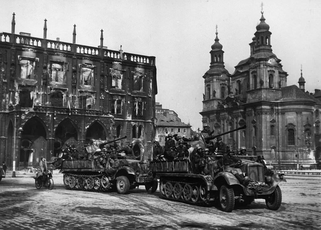 #14 View of German troops exiting Prague in trucks after their surrender, Czechoslovakia, World War II.