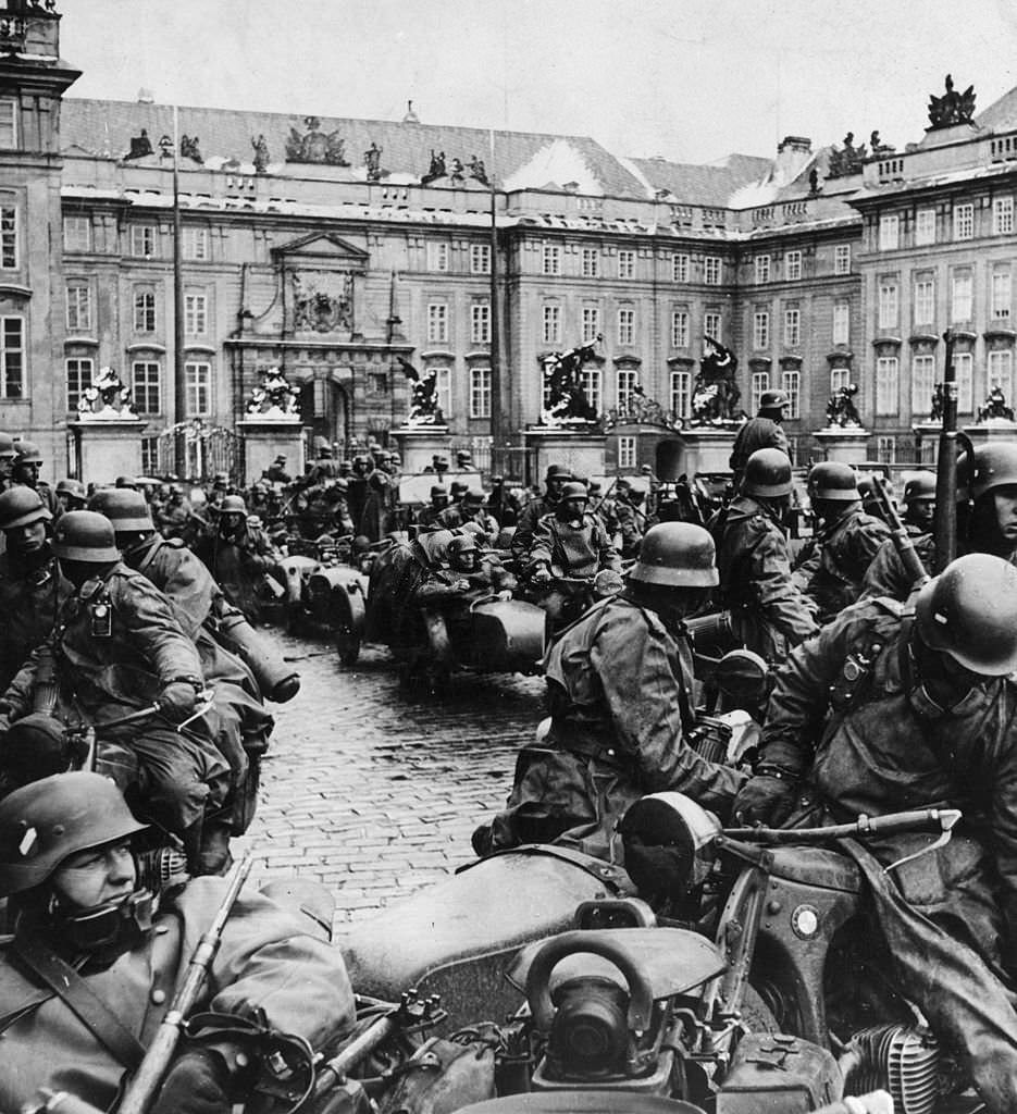#60 German soldiers on motorbikes during the invasion of Prague, Czechoslovakia.