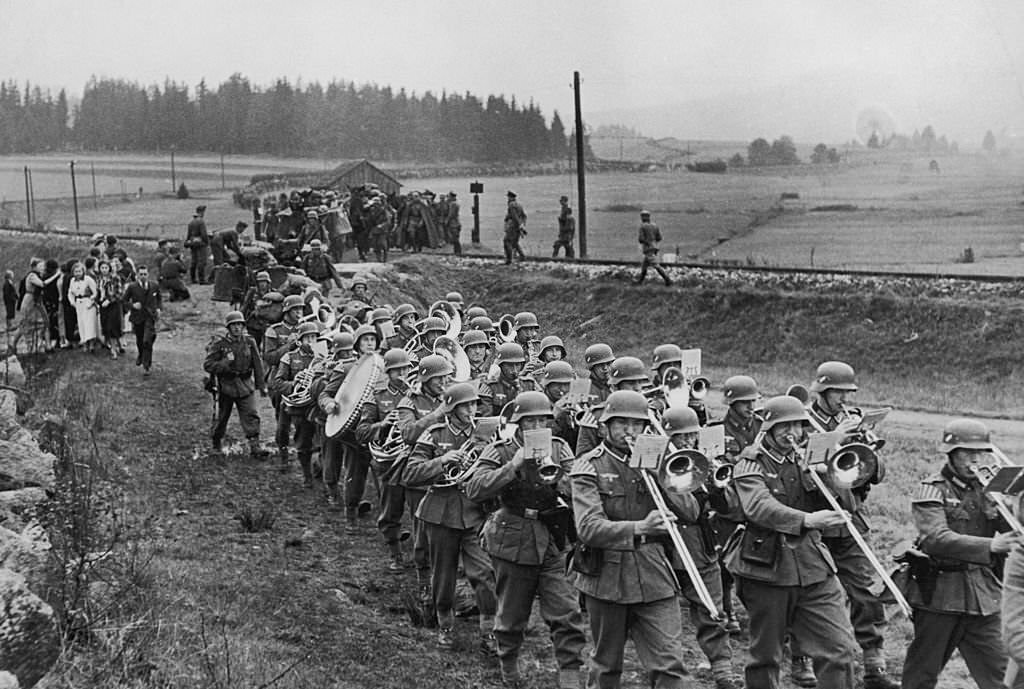 #81 A German marching band crosses the border near Haidmuhle in Bavaria to enter the Sudetenland, as Germany begins its annexation of the region, 1st October 1938.