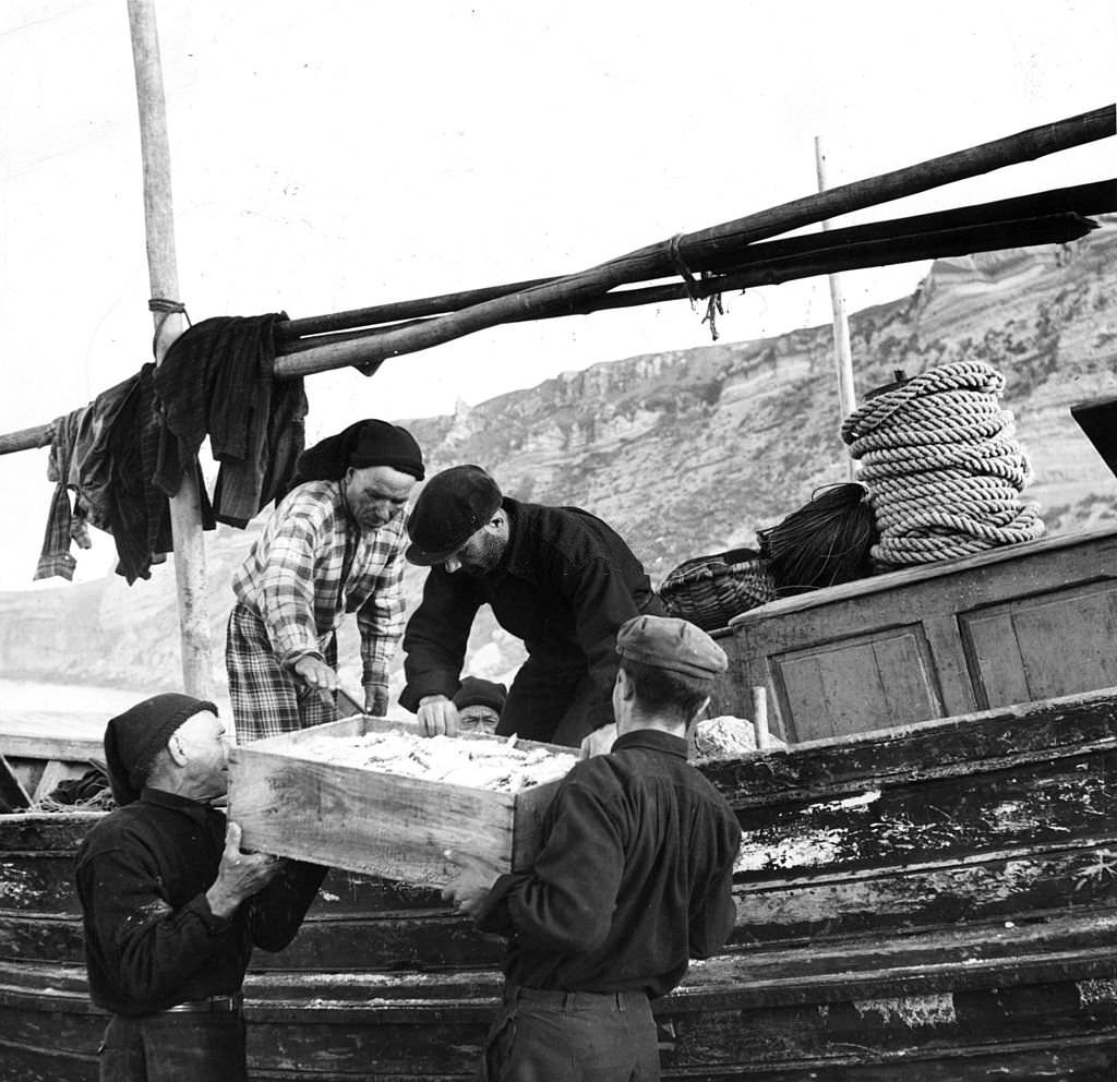 #32 Fishermen in Nazare, Portugal, with their catch.