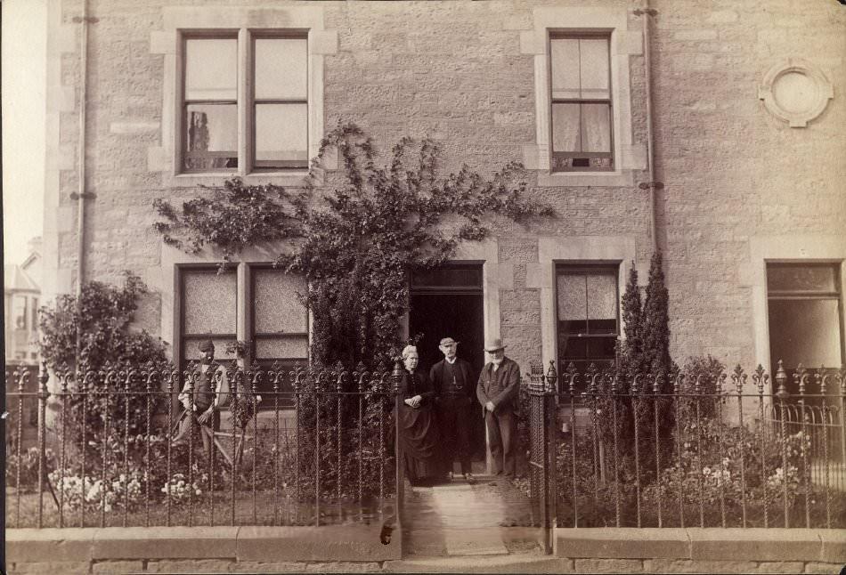 #171 Portrait of two young children outside stone house, 1900s