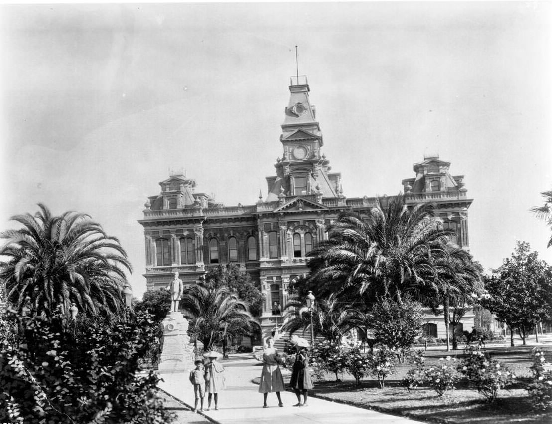 #217 Four children posing in the courtyard in front of the San Jose City Hall, 1907